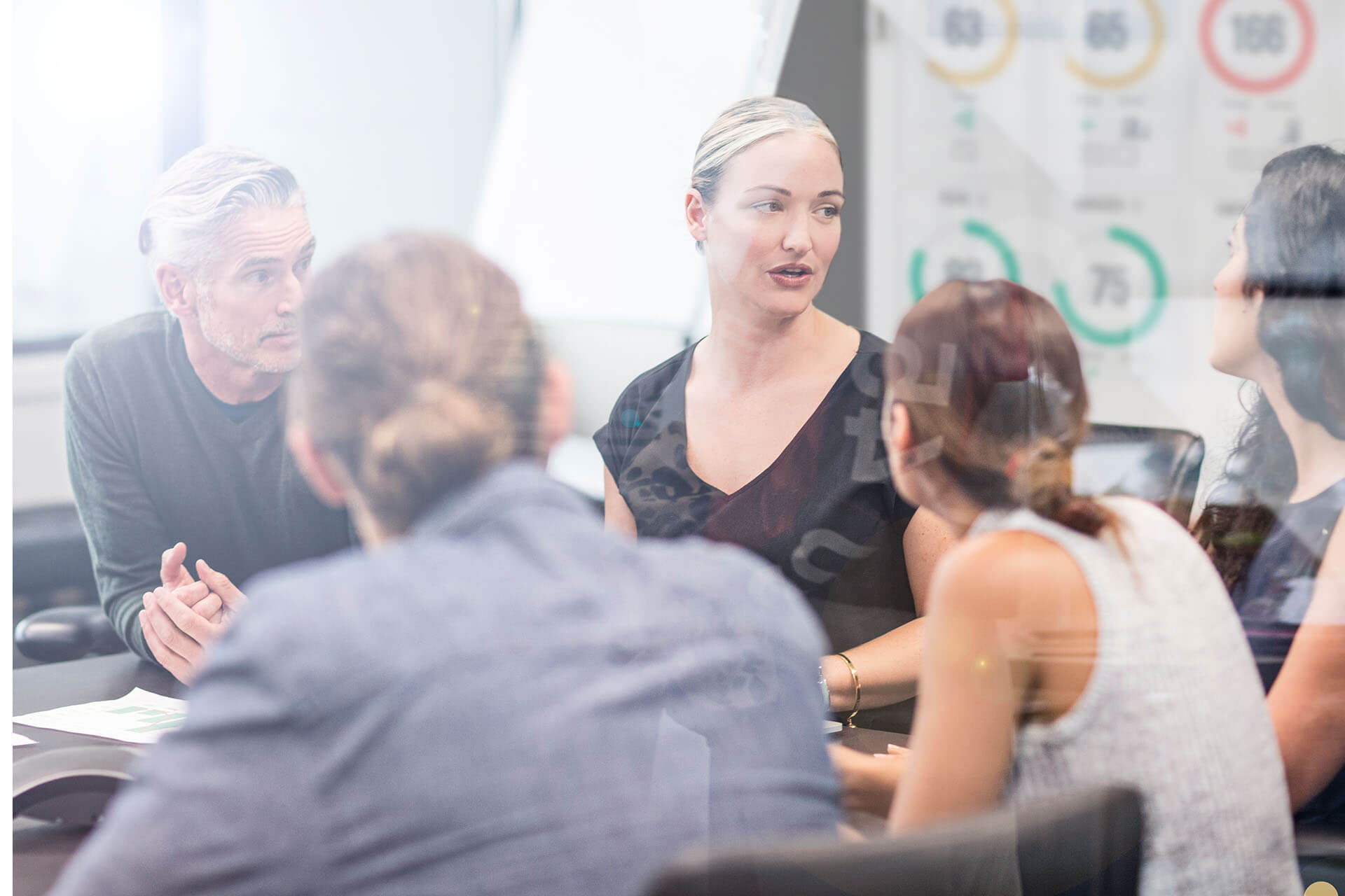 An engaged team discussing their Teamgage results during a meeting, driving improvement from the ground up.